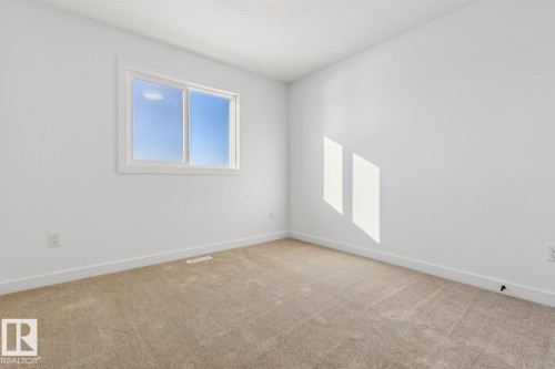 Room featuring a double-pane window, neutral carpet, white baseboards, and white walls - 39 Caledon Crescent, Spruce Grove, AB - Indoor Photo Showing Other Room
