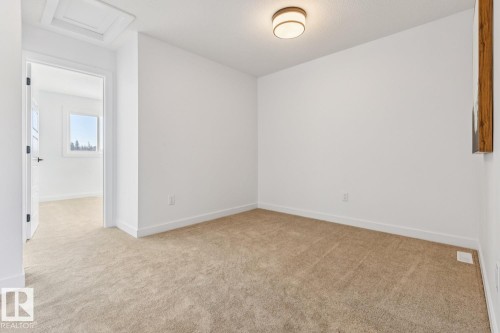 Carpeted interior room featuring white walls and a contemporary flush-mount ceiling light - 39 Caledon Crescent, Spruce Grove, AB - Indoor Photo Showing Other Room