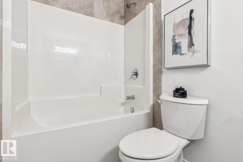 White tub and shower combination unit with chrome fixtures - 39 Caledon Crescent, Spruce Grove, AB - Indoor Photo Showing Bathroom