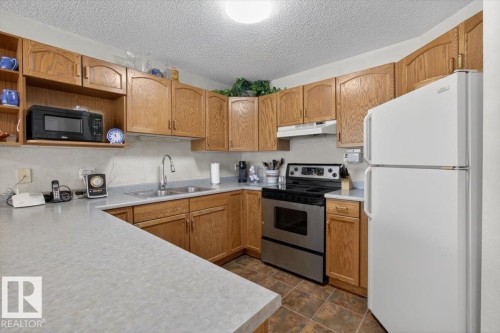 105 5212 25 Avenue Nw, Edmonton, AB - Indoor Photo Showing Kitchen With Double Sink