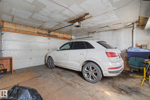 Enclosed garage space with a concrete floor and a single garage door - 4106 38 Street, Edmonton, AB - Indoor Photo Showing Garage
