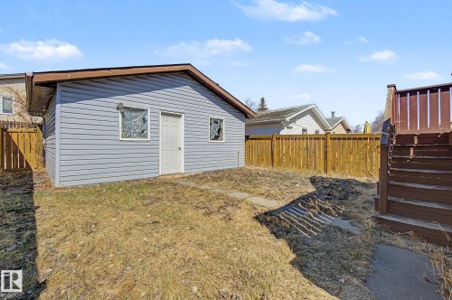 Detached outbuilding with light blue horizontal siding, a brown trim roofline, and a white entry door - 4106 38 Street, Edmonton, AB - Outdoor With Exterior