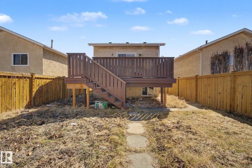 Raised wood deck with privacy railing and staircase, accessed by a glass sliding door - 4106 38 Street, Edmonton, AB - Outdoor