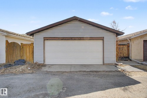 Detached garage with horizontal siding, a pitched roof, and a single roll-up garage door - 4106 38 Street, Edmonton, AB - Outdoor With Exterior
