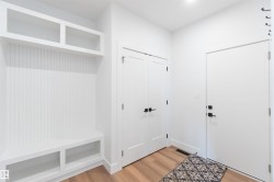Built-in hall tree with beadboard backing, overhead shelving, and integrated bench storage - 
