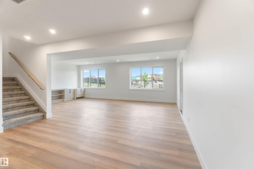 Spacious room featuring light wood-finish flooring, recessed lighting, and white walls - 74 Eldridge Point(E), St. Albert, AB - Indoor Photo Showing Other Room