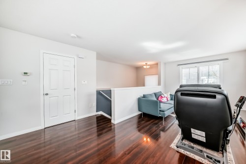Rich wood-finish flooring extending throughout the space - 45 4850 Terwillegar Common, Edmonton, AB - Indoor