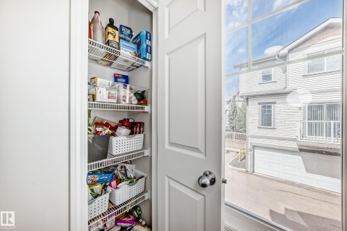 White bifold closet door with brushed nickel hardware - 45 4850 Terwillegar Common, Edmonton, AB - Indoor