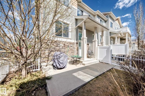 Exterior featuring horizontal siding and a stone facade - 45 4850 Terwillegar Common, Edmonton, AB - Outdoor