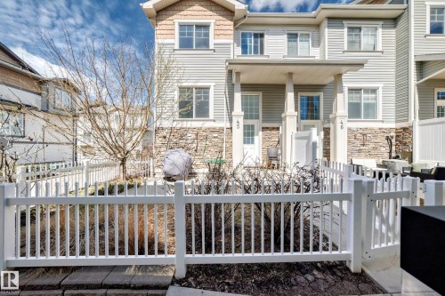 Townhome exterior featuring horizontal siding and stone veneer accents - 45 4850 Terwillegar Common, Edmonton, AB - Outdoor With Deck Patio Veranda