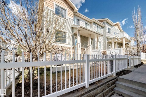 Townhome exterior featuring horizontal siding and shake siding accents - 45 4850 Terwillegar Common, Edmonton, AB - Outdoor With Deck Patio Veranda