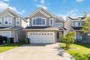 The property features a two-car garage, a paved driveway, and a well-maintained lawn - 1017 82 Street, Edmonton, AB  - Outdoor With Facade 