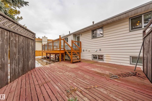 Multi-level wood deck structure with stairs and railing, complemented by horizontal siding on the property exterior - 2437 89 Street, Edmonton, AB 