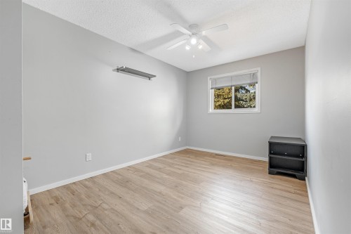 Neutral gray walls with white trim and wood-finish flooring - 2437 89 Street, Edmonton, AB 