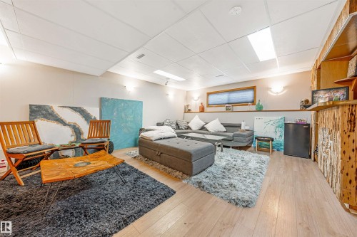 Recessed ceiling lighting illuminates this versatile room featuring wood-finish flooring - 2437 89 Street, Edmonton, AB 