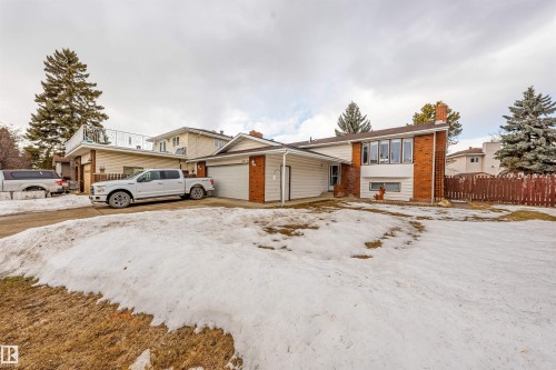 Split-level residence featuring brick and siding facade with an attached garage - 2437 89 Street, Edmonton, AB 