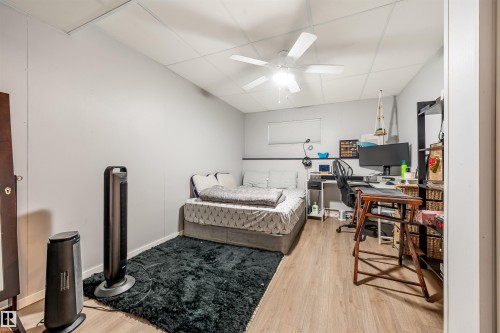 Room featuring wood-finish flooring, light gray walls, and a white ceiling fan - 2437 89 Street, Edmonton, AB 