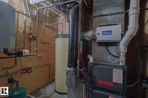 Utility room featuring a water heater, furnace, and extensive plumbing system - 10731 150 Street Nw, Edmonton, AB - Indoor Photo Showing Basement