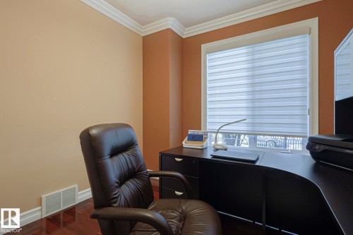 Crown molding detailing a room with warm-toned walls - 10731 150 Street Nw, Edmonton, AB - Indoor Photo Showing Office