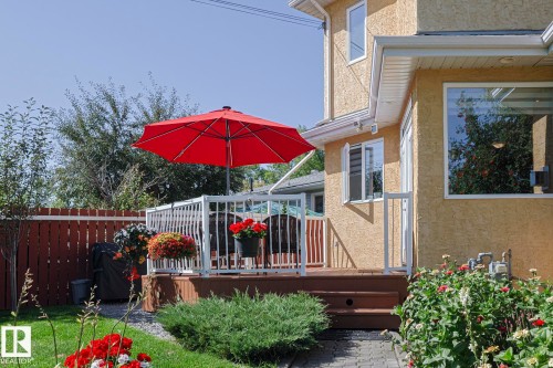Outdoor deck with white railing, wood-finish steps, and stucco exterior - 10731 150 Street Nw, Edmonton, AB - Outdoor With Deck Patio Veranda