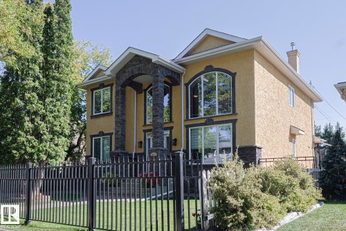 Stucco exterior with stone accents and arched entry - 10731 150 Street Nw, Edmonton, AB - Outdoor