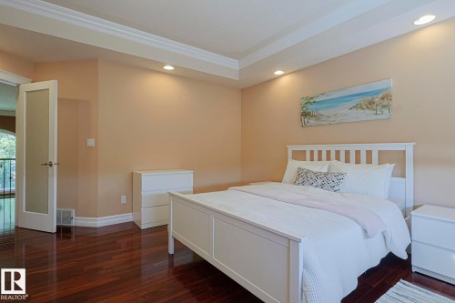 Expansive interior space featuring wood-finish flooring, recessed lighting, and tray ceiling detailing - 10731 150 Street Nw, Edmonton, AB - Indoor Photo Showing Bedroom