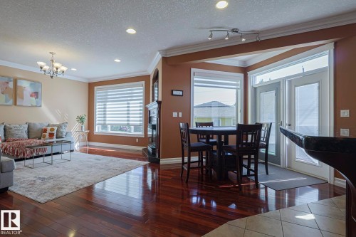 Open-concept living space featuring wood-finish flooring, recessed lighting, and crown molding - 10731 150 Street Nw, Edmonton, AB - Indoor