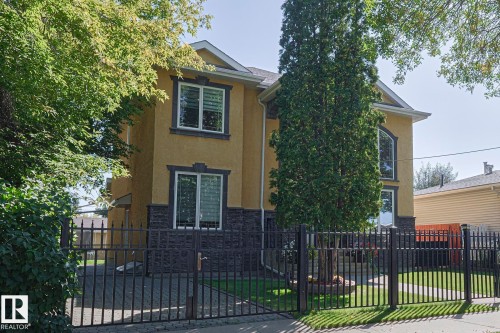 Stucco exterior with stone accents and decorative window trim - 10731 150 Street Nw, Edmonton, AB - Outdoor