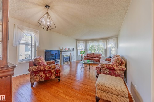 128 215 Blackburn East Drive, Edmonton, AB - Indoor Photo Showing Living Room With Fireplace