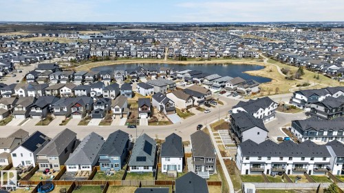 Residential development featuring a central pond with surrounding pathways - 1091 Secord Promenade, Edmonton, AB 