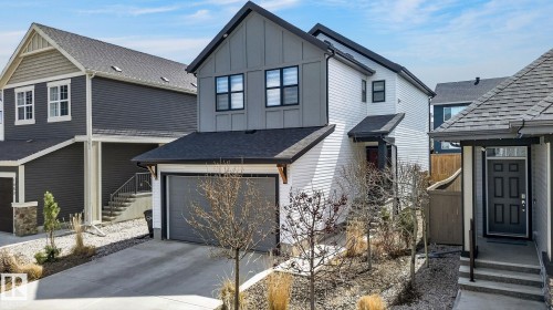 Modern two-story residence featuring a gray and white exterior with vertical and horizontal siding - 1091 Secord Promenade, Edmonton, AB 