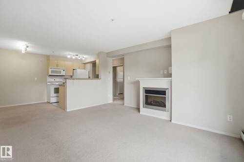 Spacious Living Room with Electric Fireplace - 214 17011 67 Avenue, Edmonton, AB - Indoor With Fireplace