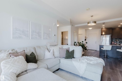 Open-concept living area with wood-finish flooring - 316 1316 Windermere Way, Edmonton, AB - Indoor Photo Showing Other Room