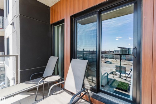 Balcony with wood-finish paneling and dark gray exterior siding - 316 1316 Windermere Way, Edmonton, AB -  With Balcony With Exterior
