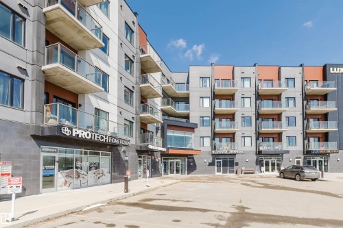Modern mixed-use building featuring residential units with private balconies and ground-floor commercial spaces - 316 1316 Windermere Way, Edmonton, AB - Outdoor With Balcony