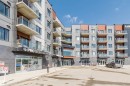 Modern mixed-use building featuring residential units with private balconies and ground-floor commercial spaces - 316 1316 Windermere Way, Edmonton, AB  - Outdoor With Balcony 