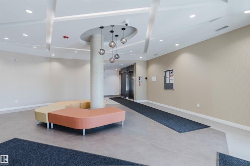 Spacious common area featuring modern ceiling lighting, recessed can lights, and textured wall coverings - 316 1316 Windermere Way, Edmonton, AB - Indoor Photo Showing Other Room