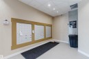 Wall-mounted mailboxes with a wood-finish surround - 316 1316 Windermere Way, Edmonton, AB  - Indoor Photo Showing Other Room 