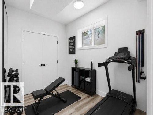 Recessed lighting, wood-finish flooring, white walls, and a white window frame - 11032 128 Street Nw, Edmonton, AB - Indoor Photo Showing Gym Room
