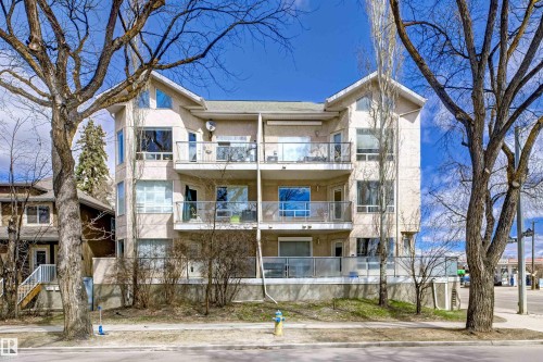 Multi-story residential building featuring a light-colored stucco exterior with multiple balconies - 101 8108 109 Street, Edmonton, AB - Outdoor