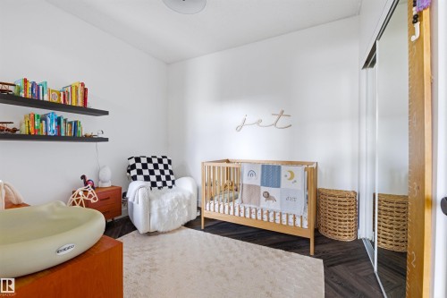 Bright room featuring dark wood-finish flooring and a light ceiling - 101 8108 109 Street, Edmonton, AB - Indoor Photo Showing Bedroom