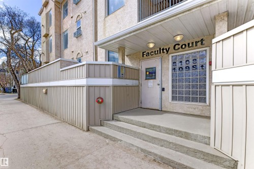 Property entrance featuring concrete steps, an overhead awning, and dual exterior light fixtures - 101 8108 109 Street, Edmonton, AB - Outdoor