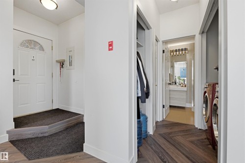 Hallway featuring herringbone wood-finish flooring, recessed lighting, and a utility closet - 101 8108 109 Street, Edmonton, AB - Indoor Photo Showing Other Room