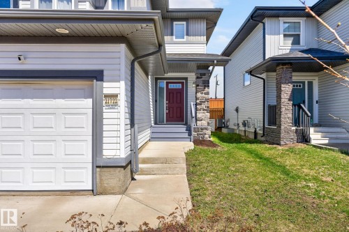 Contemporary exterior with white siding and dark trim accents - 21722 99A Avenue Nw, Edmonton, AB - Outdoor With Facade