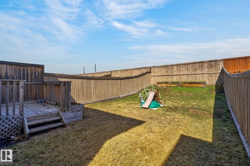 Private backyard featuring a wood deck with steps, full perimeter fencing, and a grassy area - 21722 99A Avenue Nw, Edmonton, AB - Outdoor