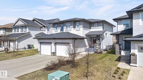 Two-story residence featuring light-colored siding and dark shingle roofing - 21722 99A Avenue Nw, Edmonton, AB - Outdoor With Facade