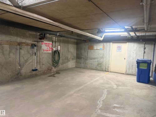 Designated parking space with concrete walls and flooring - 101 9760 174 Street, Edmonton, AB - Indoor Photo Showing Basement