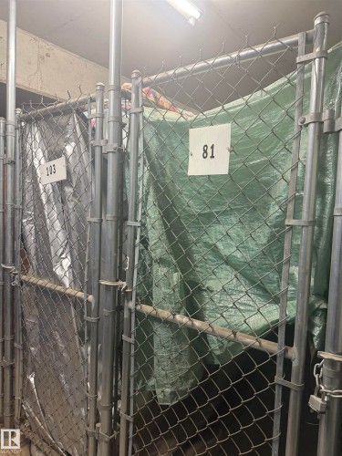 Storage cage featuring a chain link fence with a tarp covering the contents - 101 9760 174 Street, Edmonton, AB - Indoor Photo Showing Bathroom