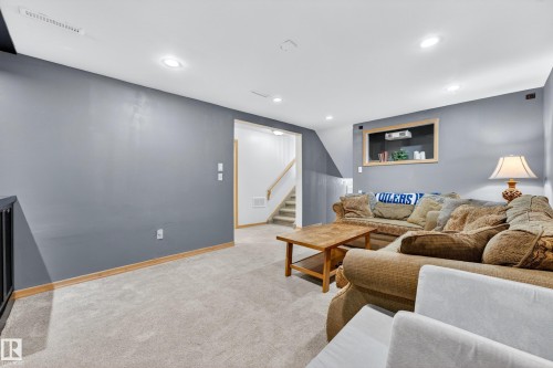 Carpeted entertainment area featuring recessed lighting and a built-in display shelf with a wood frame - 5304 90A Avenue, Edmonton, AB 