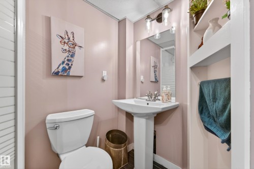 Pedestal sink with chrome fixtures and a rectangular mirror - 5304 90A Avenue, Edmonton, AB 